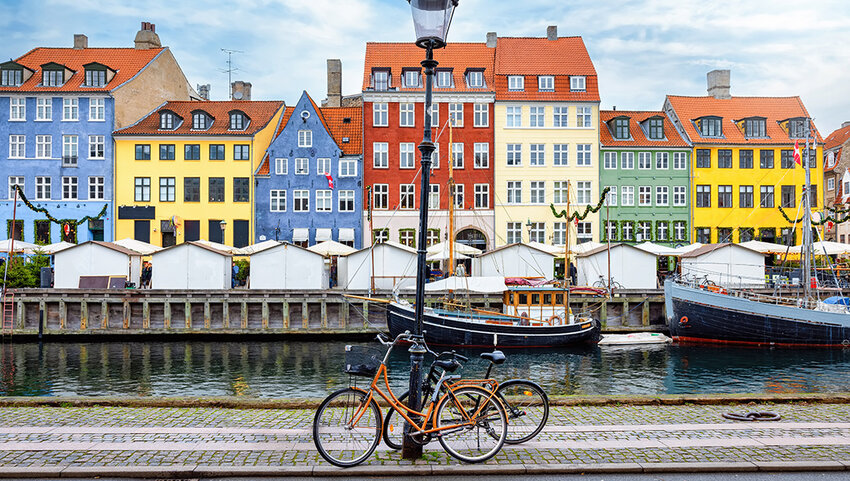 Nyhavn area at Copenhagen, Denmark, with a street light and bicycles in front of the colorful houses.