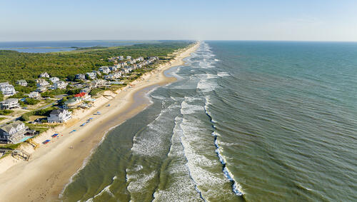 Aerial of Corolla Beach and houses along coast. 