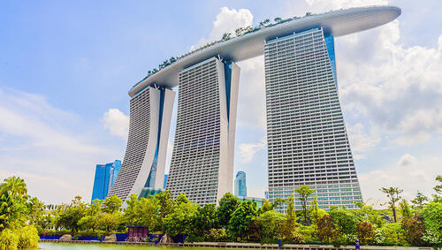 Three skyscrapers connecting by flat structure across the top. 