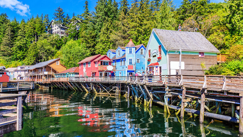 Row of colorful houses on boardwalk. 